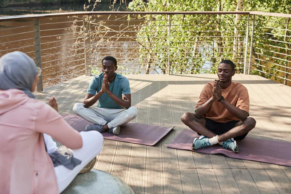 Adults during outdoor yoga Adults during outdoor yoga