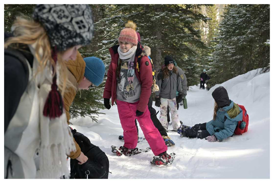Tourists snowshoe on Bear Lake Trail of Rocky Mountain National Park. Tourists snowshoe on Bear Lake Trail of Rocky Mountain National Park.