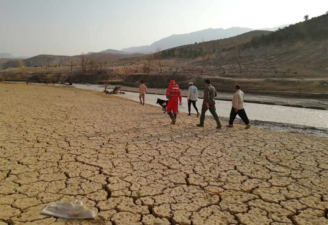 This handout photo made available by the Iranian Red Crescent Society on July 23, 2022 shows rescue workers searching near a river bank after deadly flooding in Estahban county in southern Iran This handout photo made available by the Iranian Red Crescent Society on July 23, 2022 shows rescue workers searching near a river bank after deadly flooding in Estahban county in southern Iran