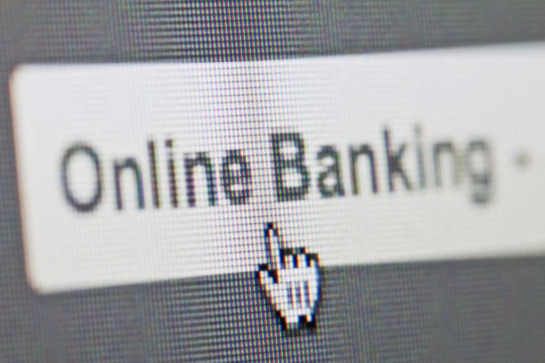 A mouse cursor clicking an online banking tab on the screen. A mouse cursor clicking an online banking tab on the screen.