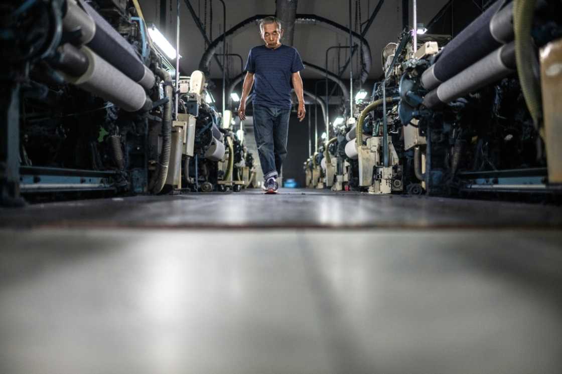 Weaving craftsman Shigeru Uchida walks between looms to detect unusual sounds that could signal a breakdown at the Momotaro Jeans factory Weaving craftsman Shigeru Uchida walks between looms to detect unusual sounds that could signal a breakdown at the Momotaro Jeans factory