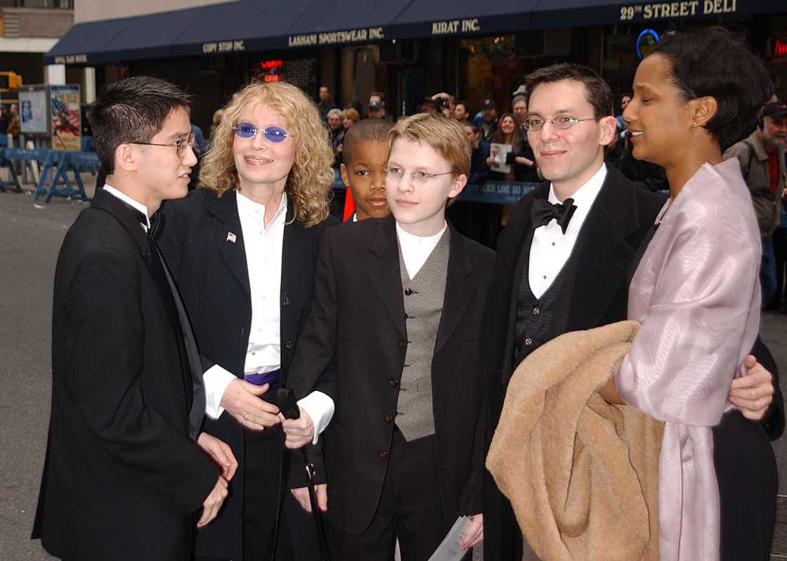 Mia Farrow (2nd-L) and her adopted children all dressed up in black suits for a wedding Mia Farrow (2nd-L) and her adopted children all dressed up in black suits for a wedding