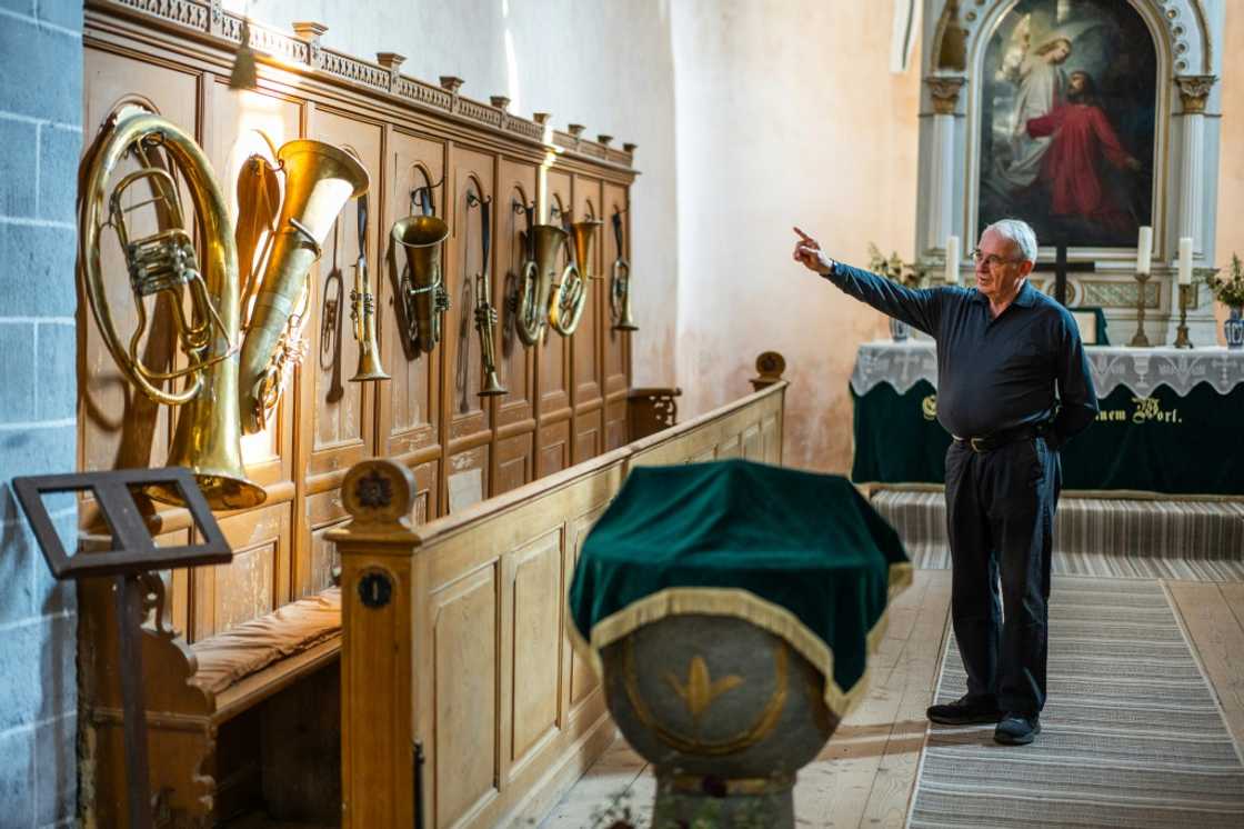 Former history teacher Michael Lisske shows off the old brass instruments inside the fortified church of Cincsor Former history teacher Michael Lisske shows off the old brass instruments inside the fortified church of Cincsor