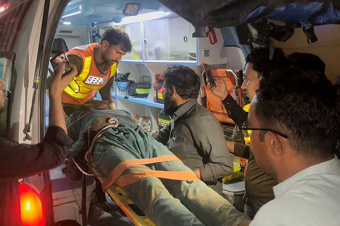 Rescue workers put the body of a victim from the Swat Valley truck blast into an ambulance Rescue workers put the body of a victim from the Swat Valley truck blast into an ambulance