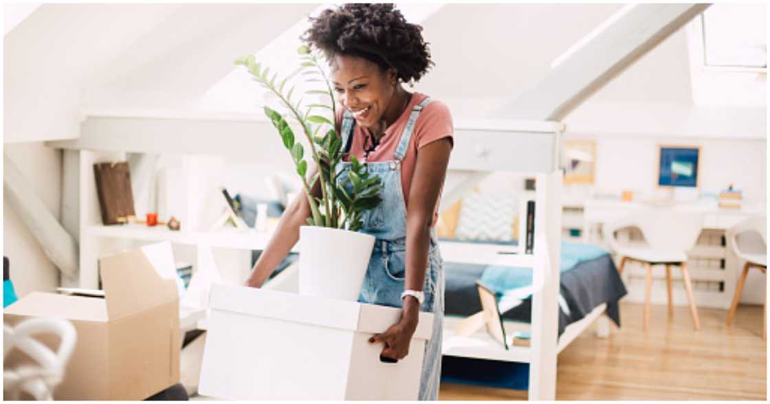 A woman joyfully moves into her dream apartment