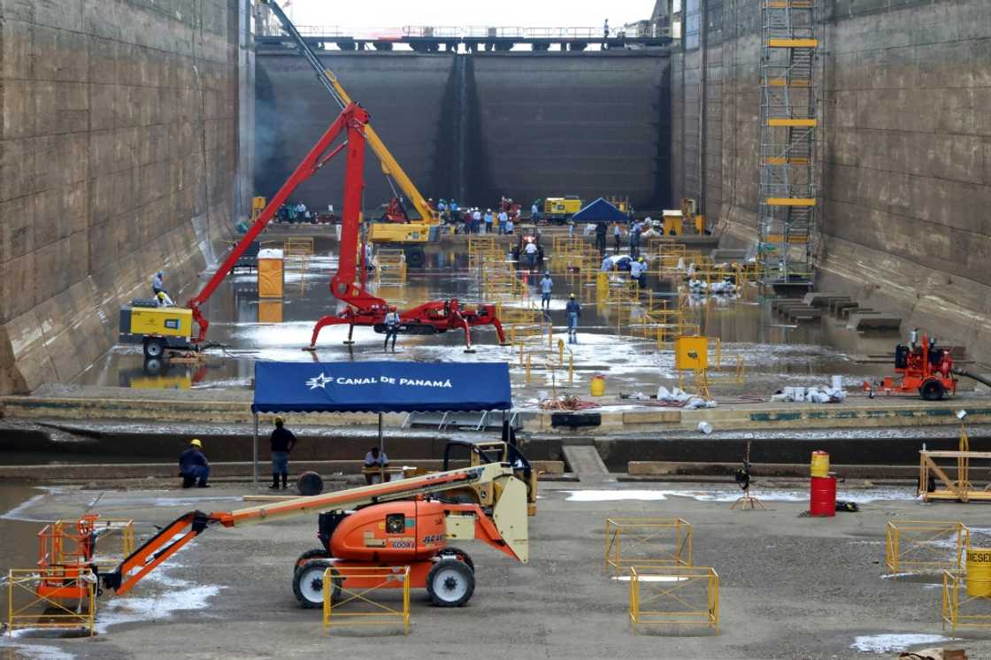 Workers perform maintenance in one of the chambers of the Pedro Miguel locks of the Panama Canal, not far from Panama City, on May 12, 2023