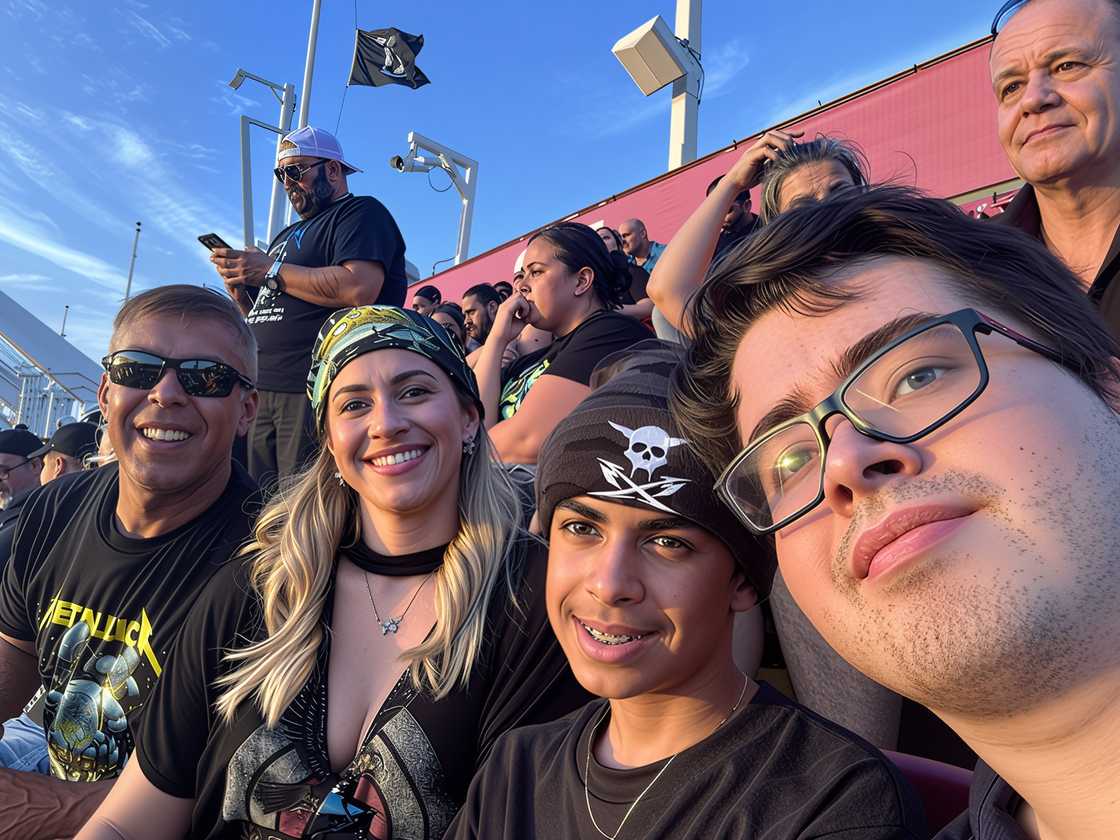Marcela Borges and her family seated at a stadium event. Marcela Borges and her family seated at a stadium event.