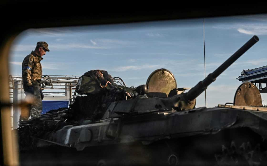 A Ukrainian fighter stands on the top of a tank in Kharkiv A Ukrainian fighter stands on the top of a tank in Kharkiv