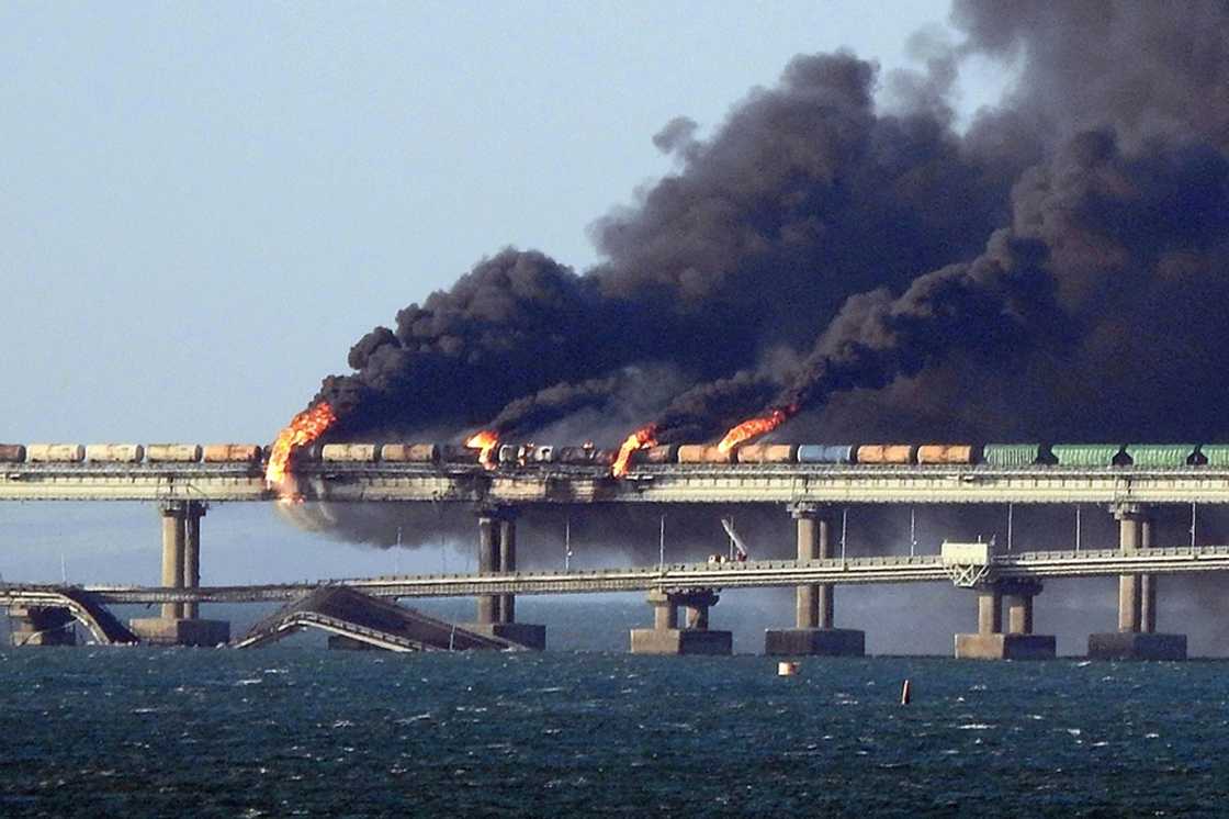Black smoke billows from a fire on the Kerch bridge that links Crimea to Russia, after a truck exploded, near Kerch, on October 8, 2022 Black smoke billows from a fire on the Kerch bridge that links Crimea to Russia, after a truck exploded, near Kerch, on October 8, 2022