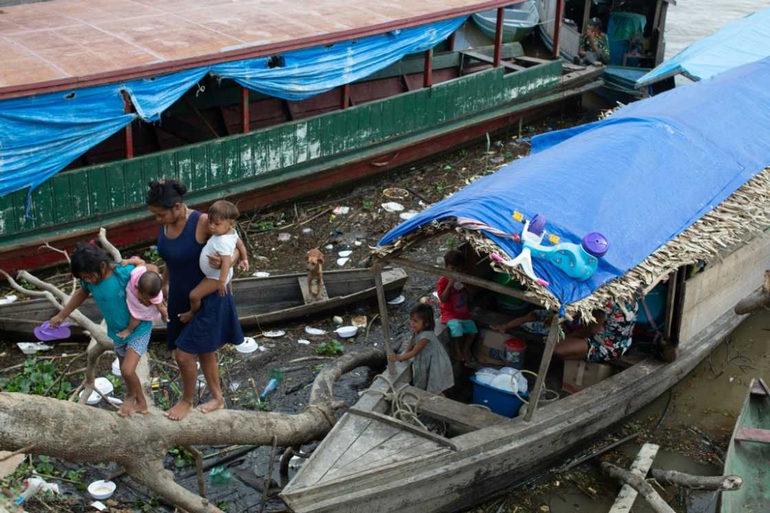 Experts say poverty is fueling crime in Brazil's Javari Valley -- here, an Indigenous family is termporarily living on this boat Experts say poverty is fueling crime in Brazil's Javari Valley -- here, an Indigenous family is termporarily living on this boat
