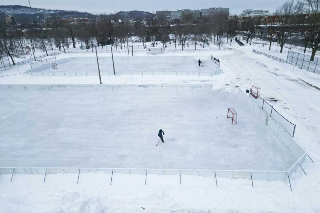 A hockey player skates on one of the few open outdoor ice rinks at Laurier Park in Motnreal A hockey player skates on one of the few open outdoor ice rinks at Laurier Park in Motnreal