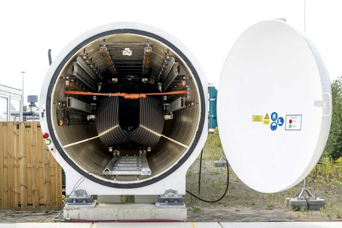 The dark and light grey striped pod inside the hyperloop tunnel at the European Hyperloop Center (EHC) testing facility in Veendam