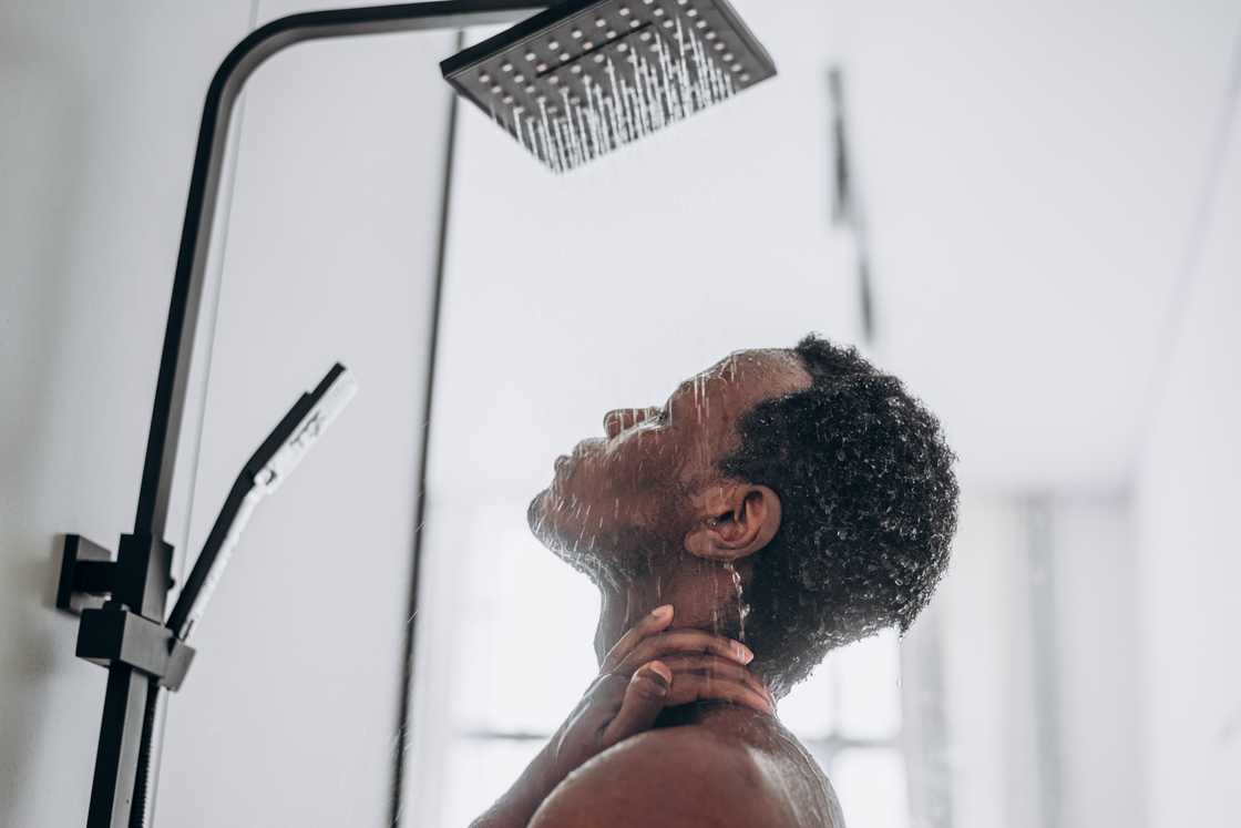 A man takes a shower A man takes a shower