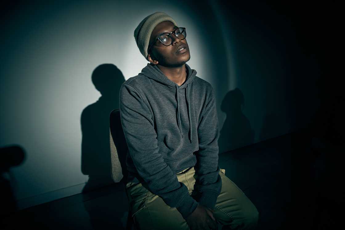 A stressed man in a dark room A stressed man in a dark room