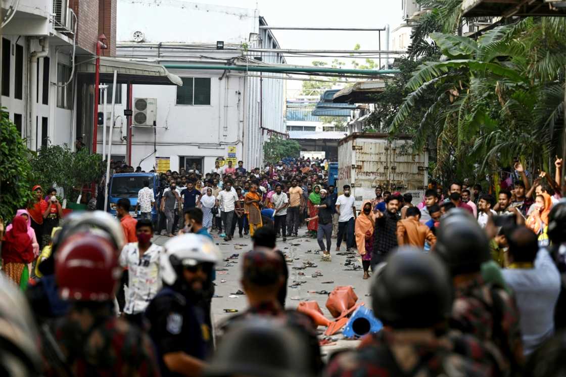 Garment workers clash with police during a rally in Gazipur on November 9. They are demanding a minimum wage of around $208 a month Garment workers clash with police during a rally in Gazipur on November 9. They are demanding a minimum wage of around $208 a month