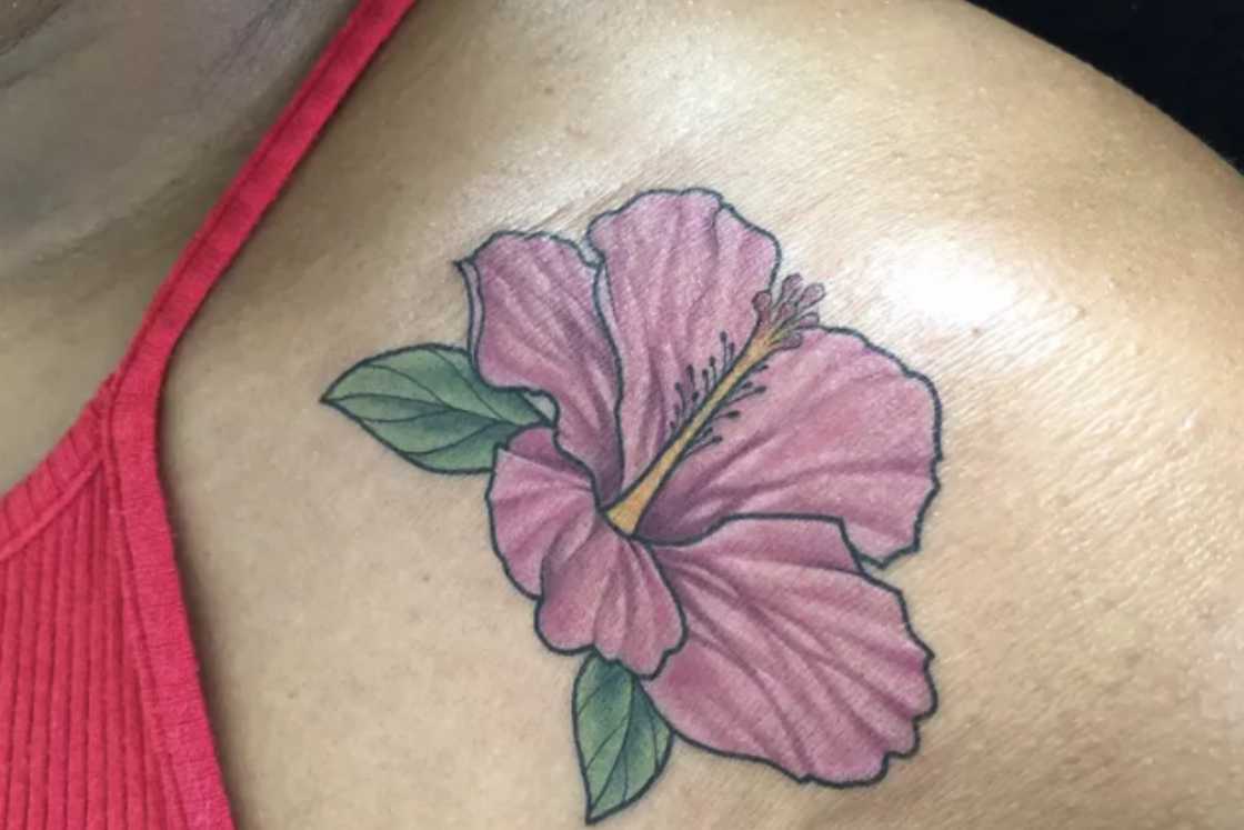 A purple hibiscus shoulder tattoo A purple hibiscus shoulder tattoo
