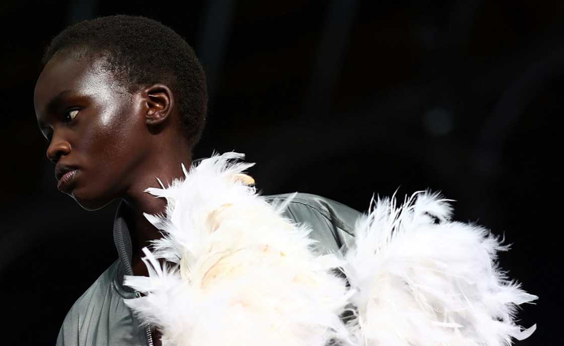 JW Anderson's show included colourful ensembles from a plastic material, crochet dresses and feathers worn as belts and on sleeves JW Anderson's show included colourful ensembles from a plastic material, crochet dresses and feathers worn as belts and on sleeves