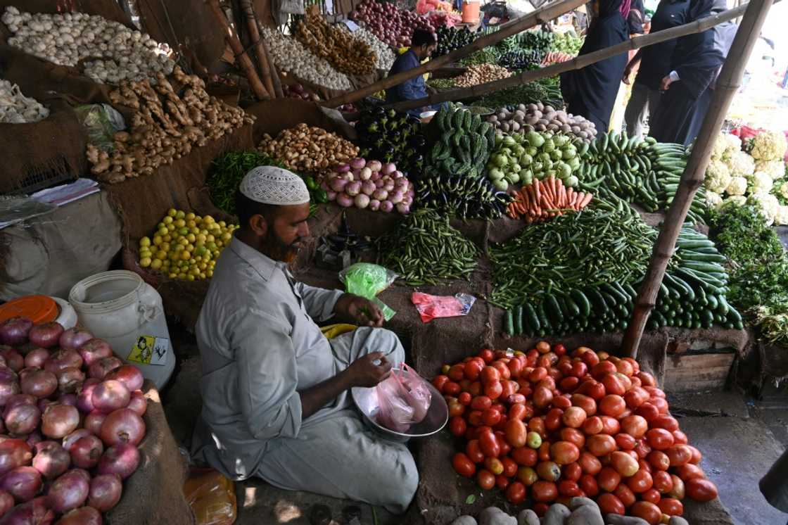 A vegetable vendor at his market stall in Lahore A vegetable vendor at his market stall in Lahore