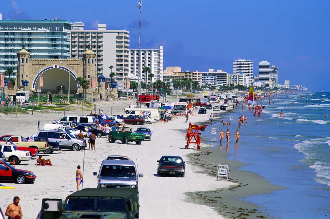 People on the beach beside waterfront hotels in the USA, Florida, Daytona Beach