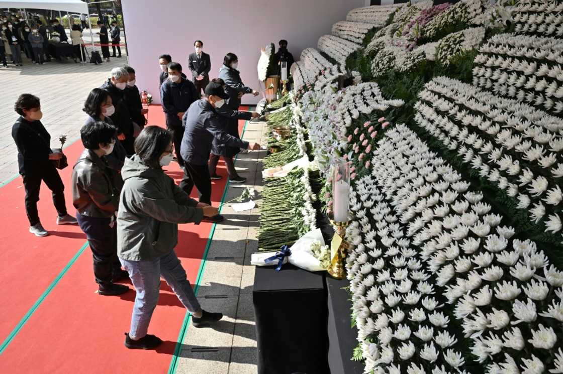 Mourners pay tribute in front of a joint memorial altar for victims of the deadly Halloween crowd surge in Seoul Mourners pay tribute in front of a joint memorial altar for victims of the deadly Halloween crowd surge in Seoul