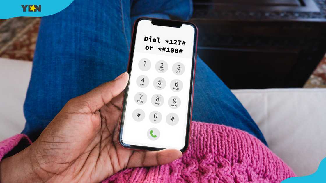 A black woman sitting on a couch holding a smartphone.