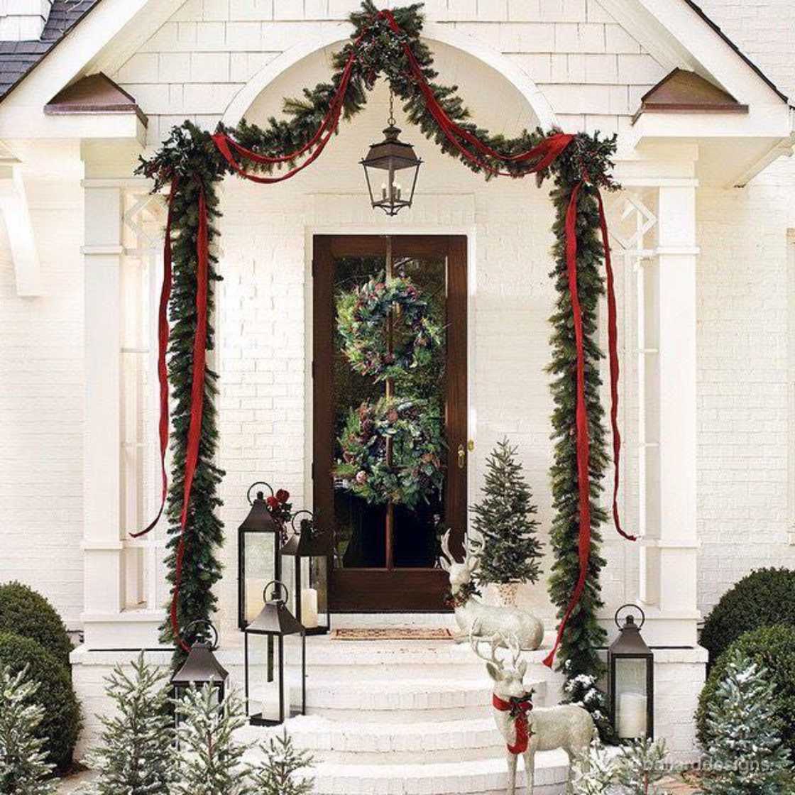 A house is decorated with convectional evergreen garland A house is decorated with convectional evergreen garland