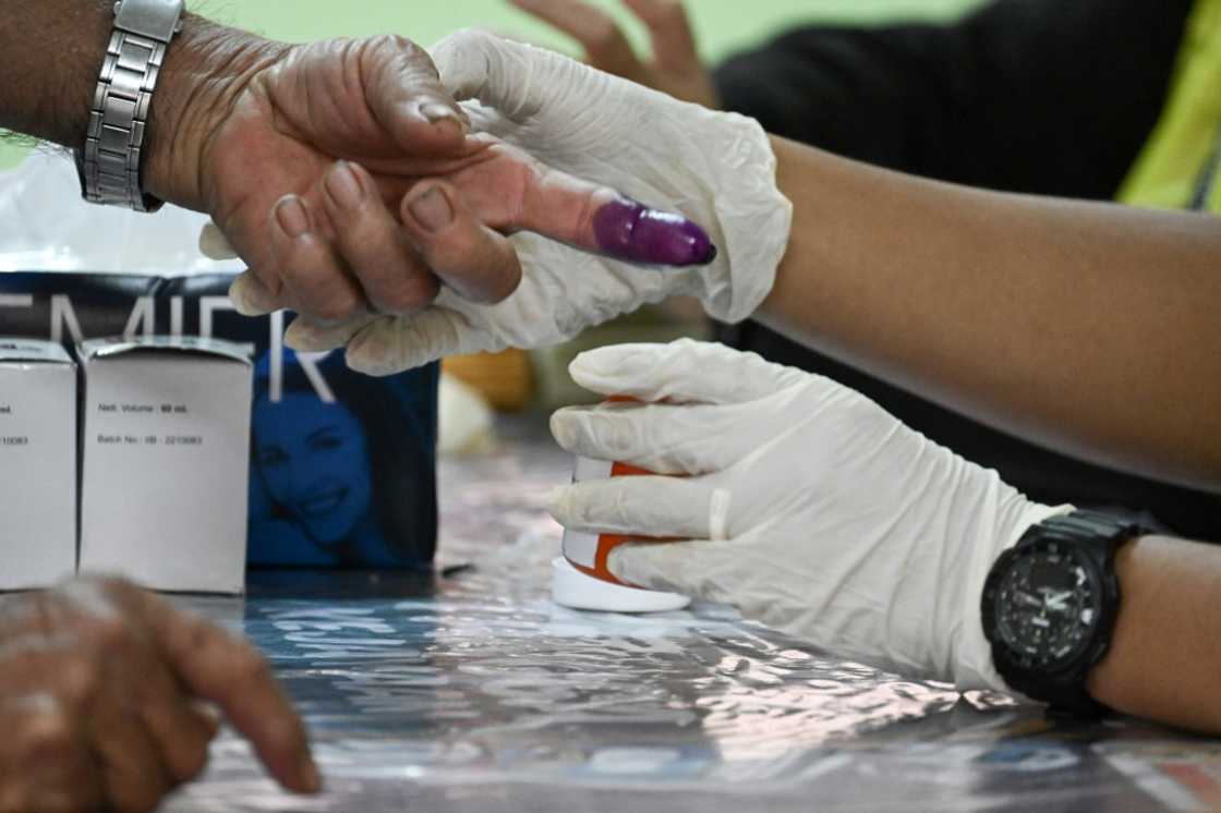 A man gets his finger inked before casting his ballot at a polling station in Bera, Malaysia on Saturday A man gets his finger inked before casting his ballot at a polling station in Bera, Malaysia on Saturday