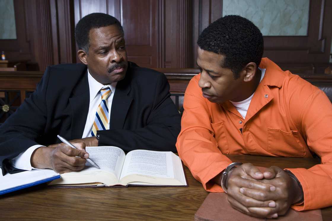 A lawyer visits a relative in a prison meeting room. A lawyer visits a relative in a prison meeting room.