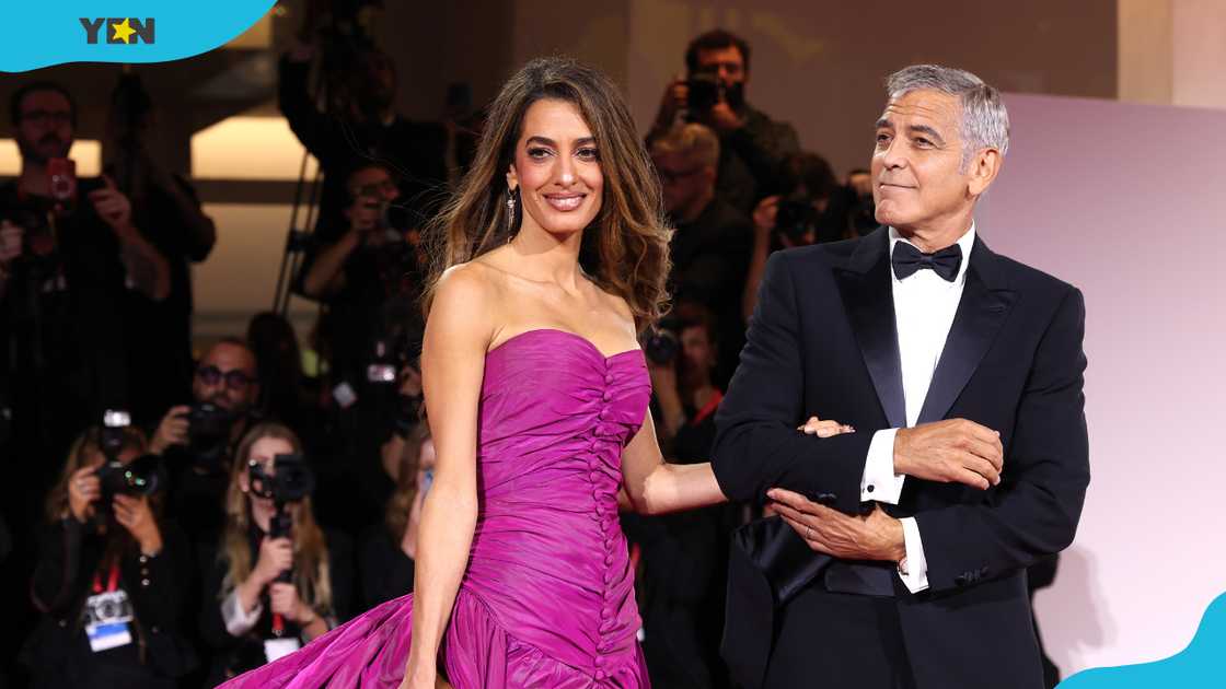 Amal Clooney and George Clooney during the "Jay Kelly" red carpet