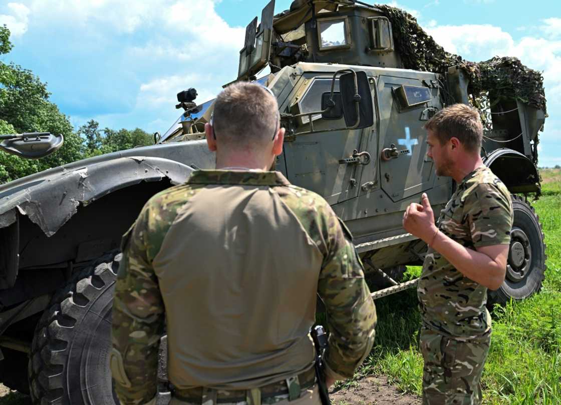 Ukrainian commander 'Spartanets' (L) said that the American Oshkosh vehicles were very good for protection Ukrainian commander 'Spartanets' (L) said that the American Oshkosh vehicles were very good for protection