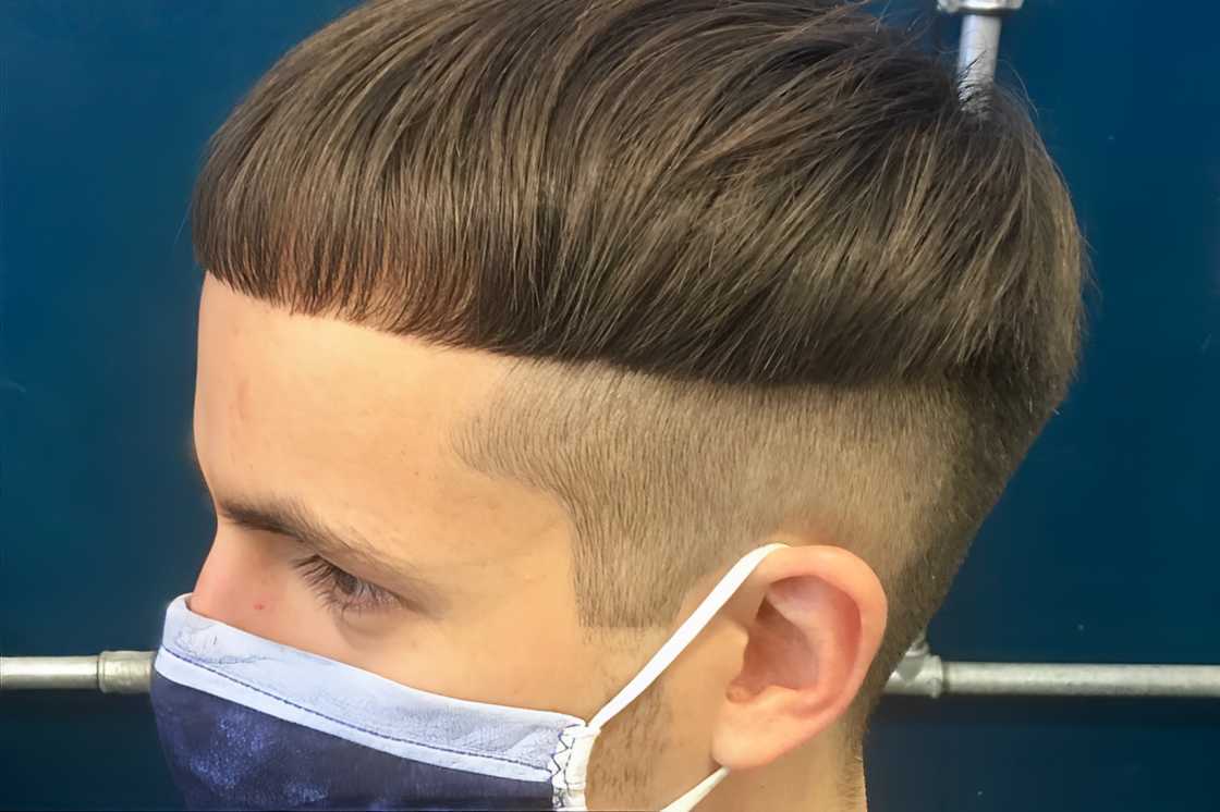 A young white man is rocking a tapered bowl cut A young white man is rocking a tapered bowl cut