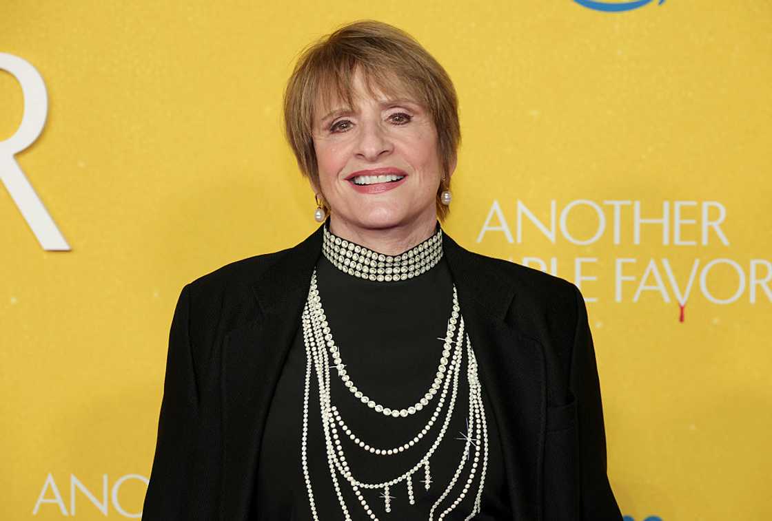 Patti LuPone in an all-black attire with pearl embellishments Patti LuPone in an all-black attire with pearl embellishments