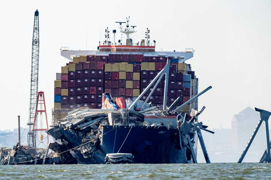 A section of the Francis Scott Key Bridge rests in the water next to the Dali container ship in Baltimore on May 13, 2024, after crews conducted a controlled demolition A section of the Francis Scott Key Bridge rests in the water next to the Dali container ship in Baltimore on May 13, 2024, after crews conducted a controlled demolition