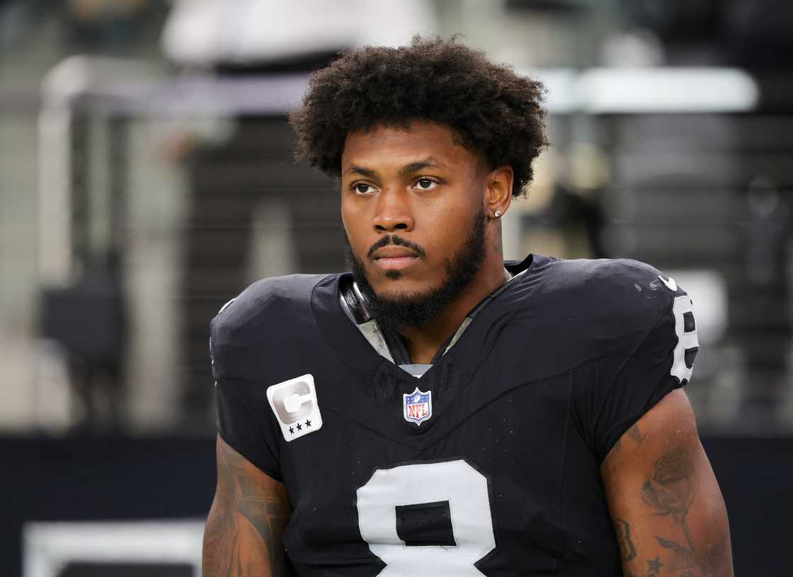 Josh Jacobs looks on as the United States national anthem is performed