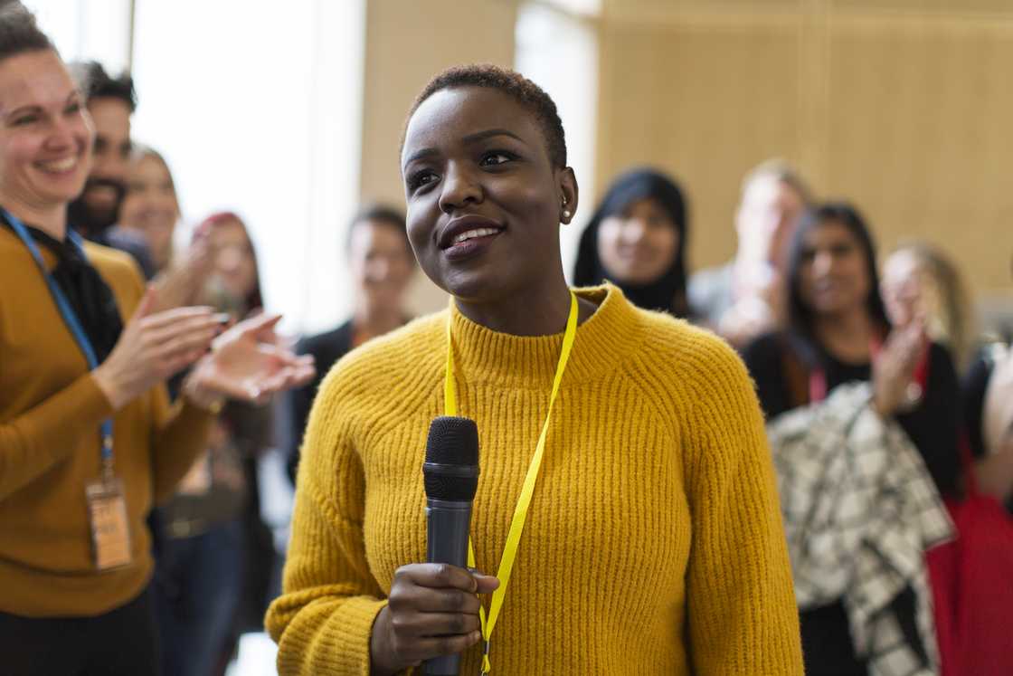 A woman addressing a small audience. A woman addressing a small audience.