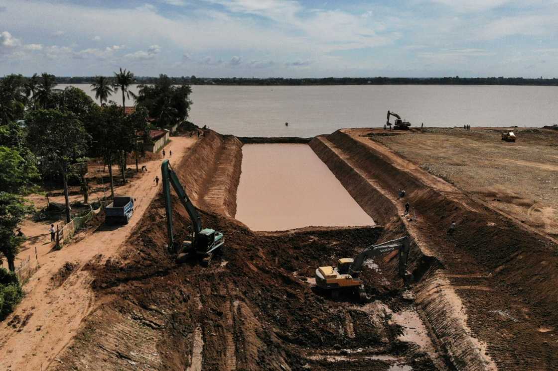 Workers use excavators to dig the Funan Techo canal, a $1.7 billion project that will run from the Mekong river to the Gulf of Thailand