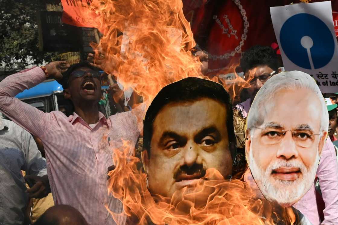 An activist with India's opposition Congress party shouts slogans in Kolkata as he burns an effigy of Prime Minister Narendra Modi and tycoon Gautam Adani to protest against the government's financial policies An activist with India's opposition Congress party shouts slogans in Kolkata as he burns an effigy of Prime Minister Narendra Modi and tycoon Gautam Adani to protest against the government's financial policies
