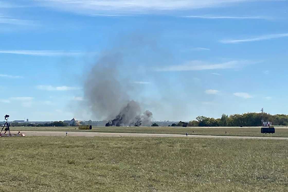 Smoke rises from the crash site after two planes collided mid-air during the Wings Over Dallas Airshow on November 12, 2022 Smoke rises from the crash site after two planes collided mid-air during the Wings Over Dallas Airshow on November 12, 2022
