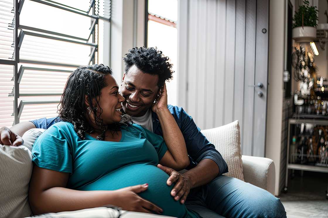 A couple touching her pregnant belly