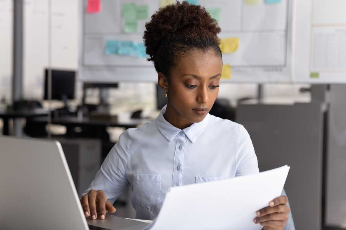 A lady in an office counterchecks the reports