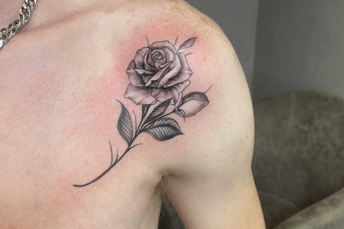 A small black and grey rose shoulder tattoo A small black and grey rose shoulder tattoo