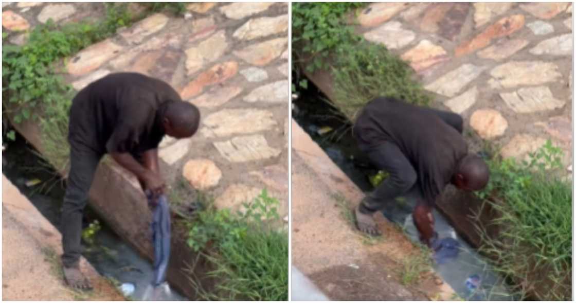 Man washing his clothes in a gutter Man washing his clothes in a gutter