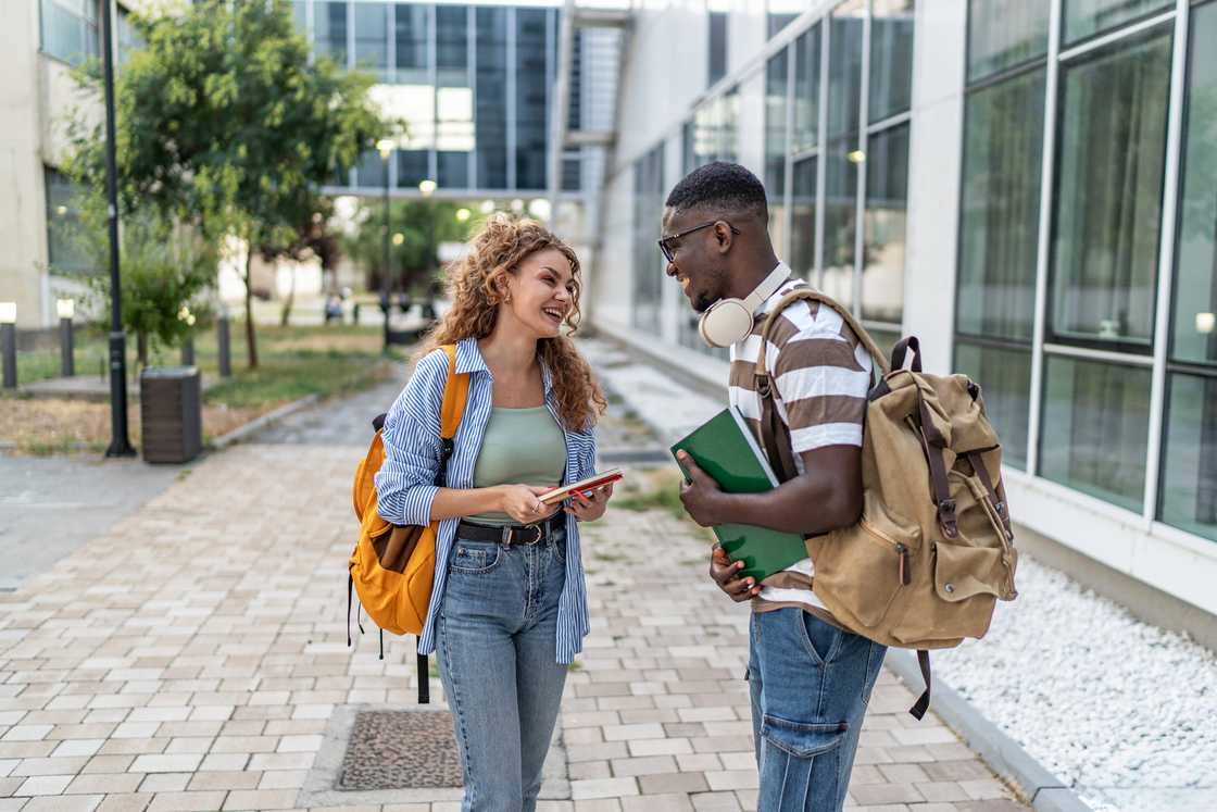 Students talking and laughing on university campus