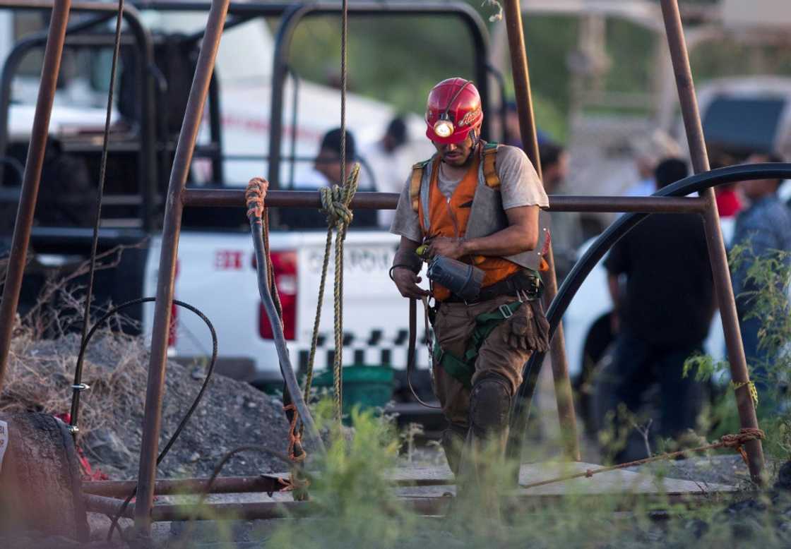 A rescuer works at a flooded coal mine in northern Mexico where 10 workers are trapped A rescuer works at a flooded coal mine in northern Mexico where 10 workers are trapped
