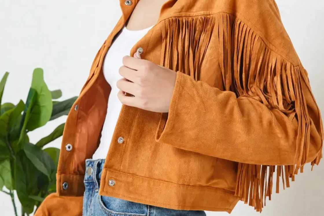 A lady is wearing a brown oversized jacket A lady is wearing a brown oversized jacket