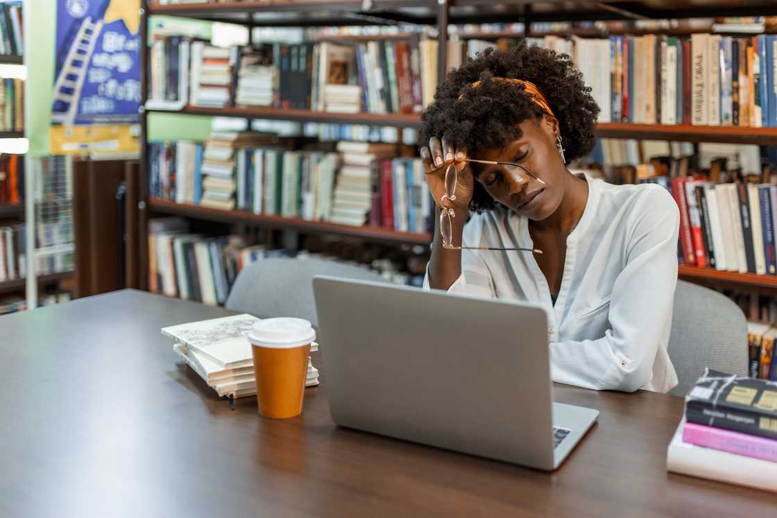A lady studies from tne library A lady studies from tne library
