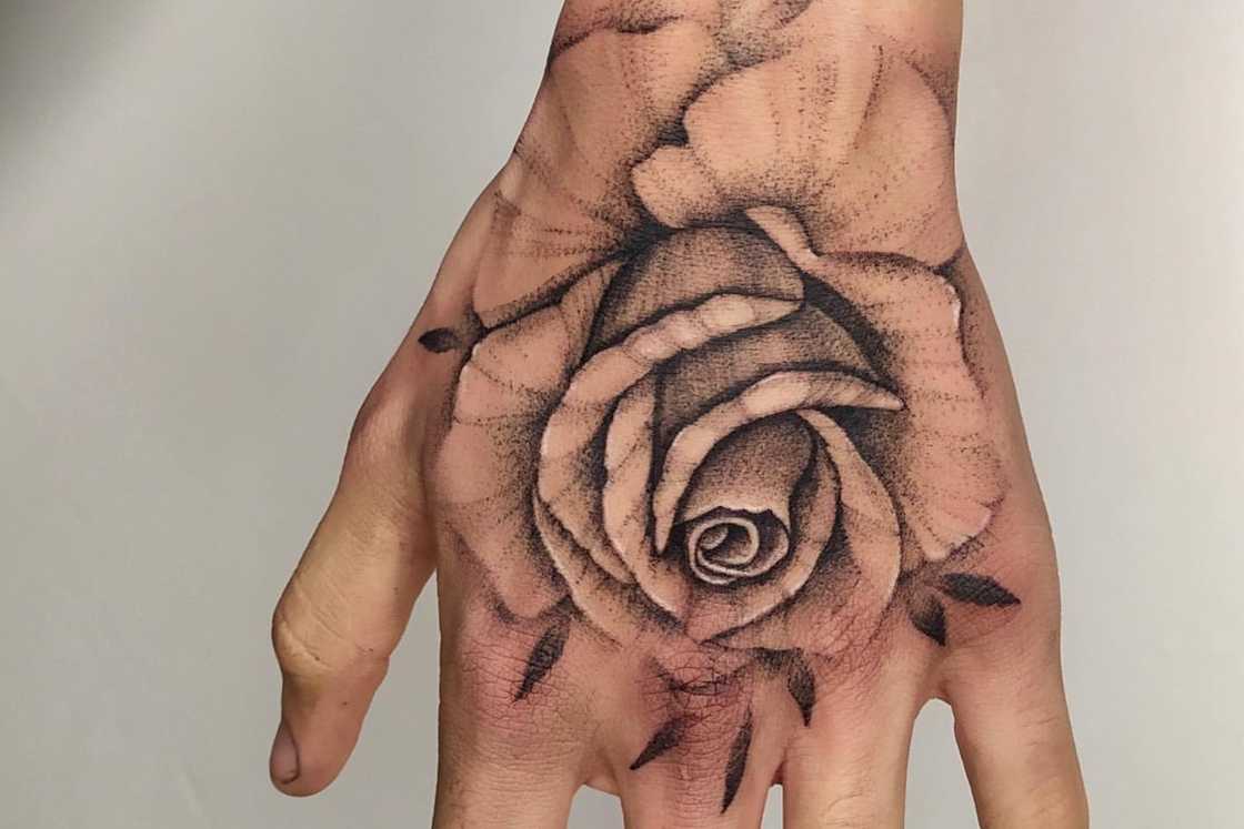 A simple and classic rose hand tattoo A simple and classic rose hand tattoo