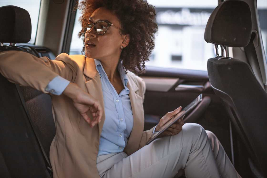 A frustrated passenger stick in traffic, checking the time. A frustrated passenger stick in traffic, checking the time.