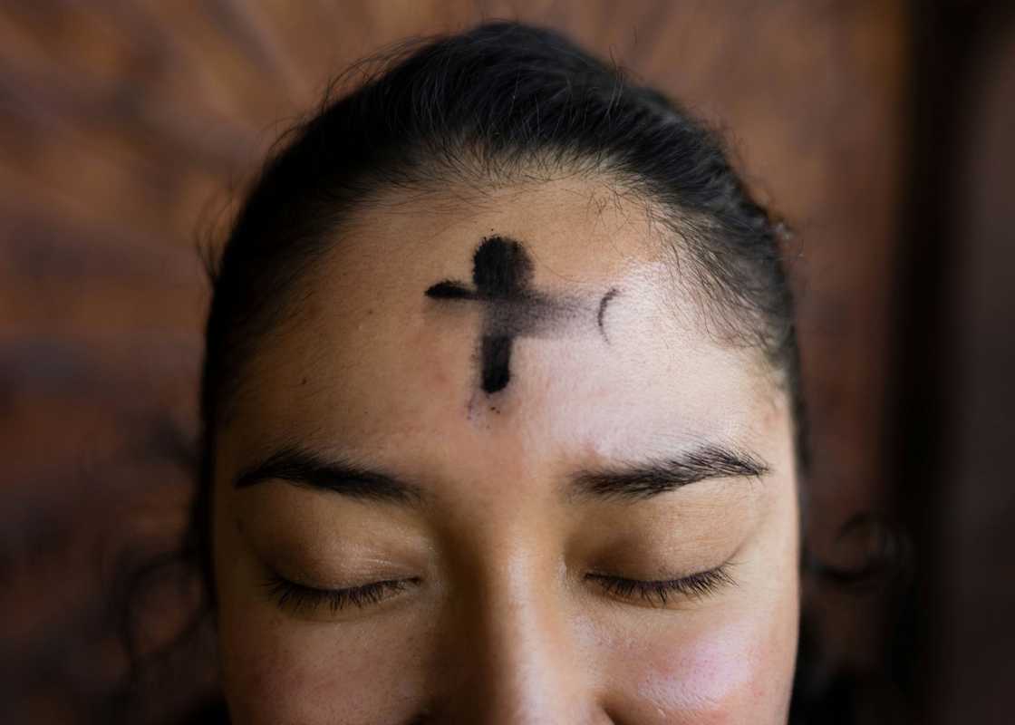 A woman with a cross on her forehead A woman with a cross on her forehead