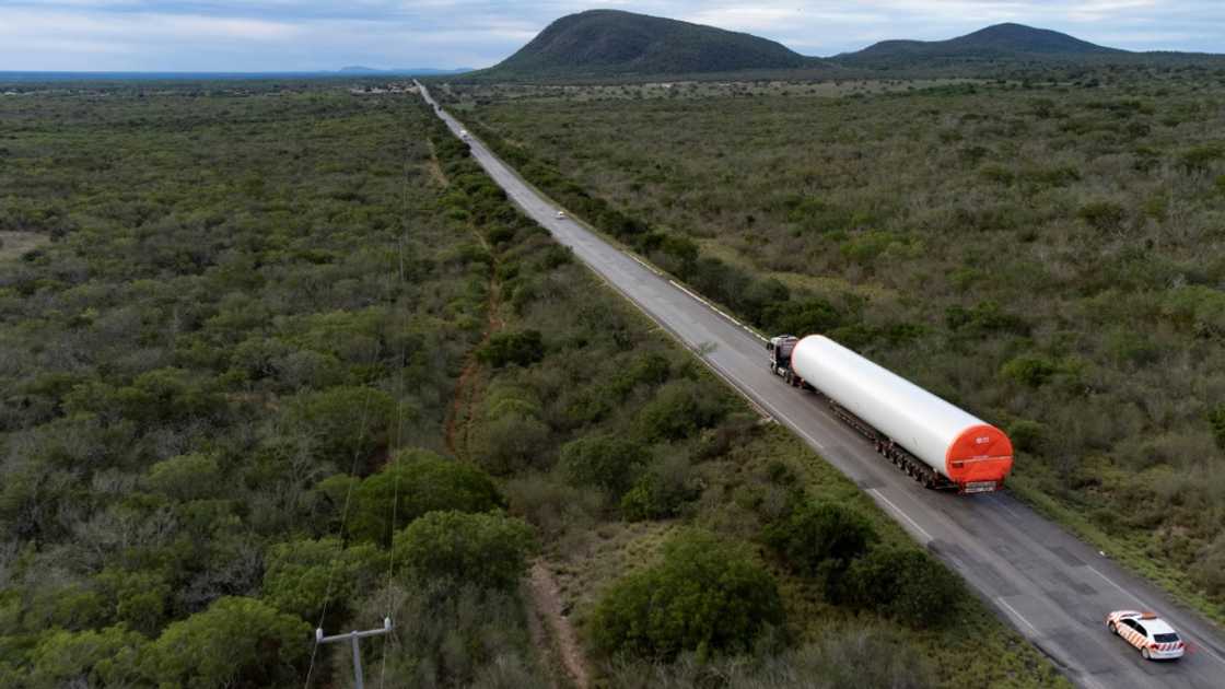 A truck transports parts of a wind turbine on the way to the Canudos Wind Energy Complex in Canudos, Bahia state, Brazil, on May 6, 2023 A truck transports parts of a wind turbine on the way to the Canudos Wind Energy Complex in Canudos, Bahia state, Brazil, on May 6, 2023